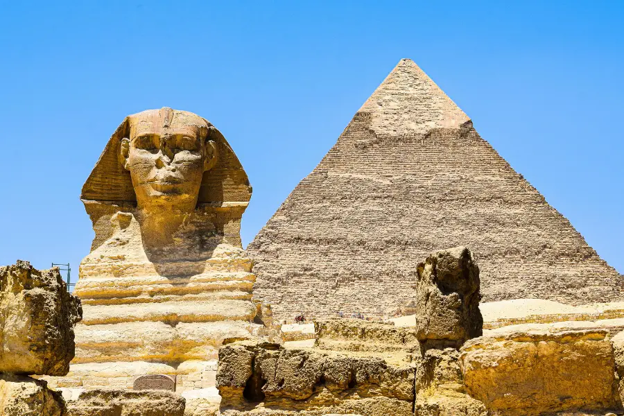 The Great Sphinx of Giza with the Great Pyramid rising behind it on the Giza Plateau, Egypt
